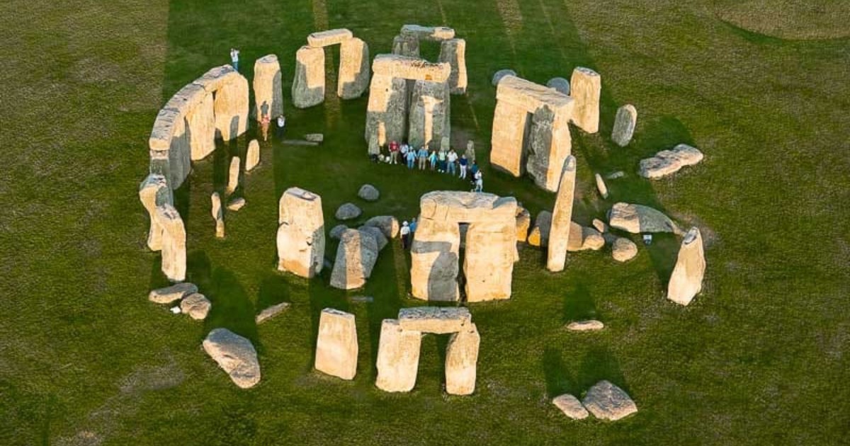 Stonehenge Inner Circle aerial view with visitors inside the stone circle during a special access experience