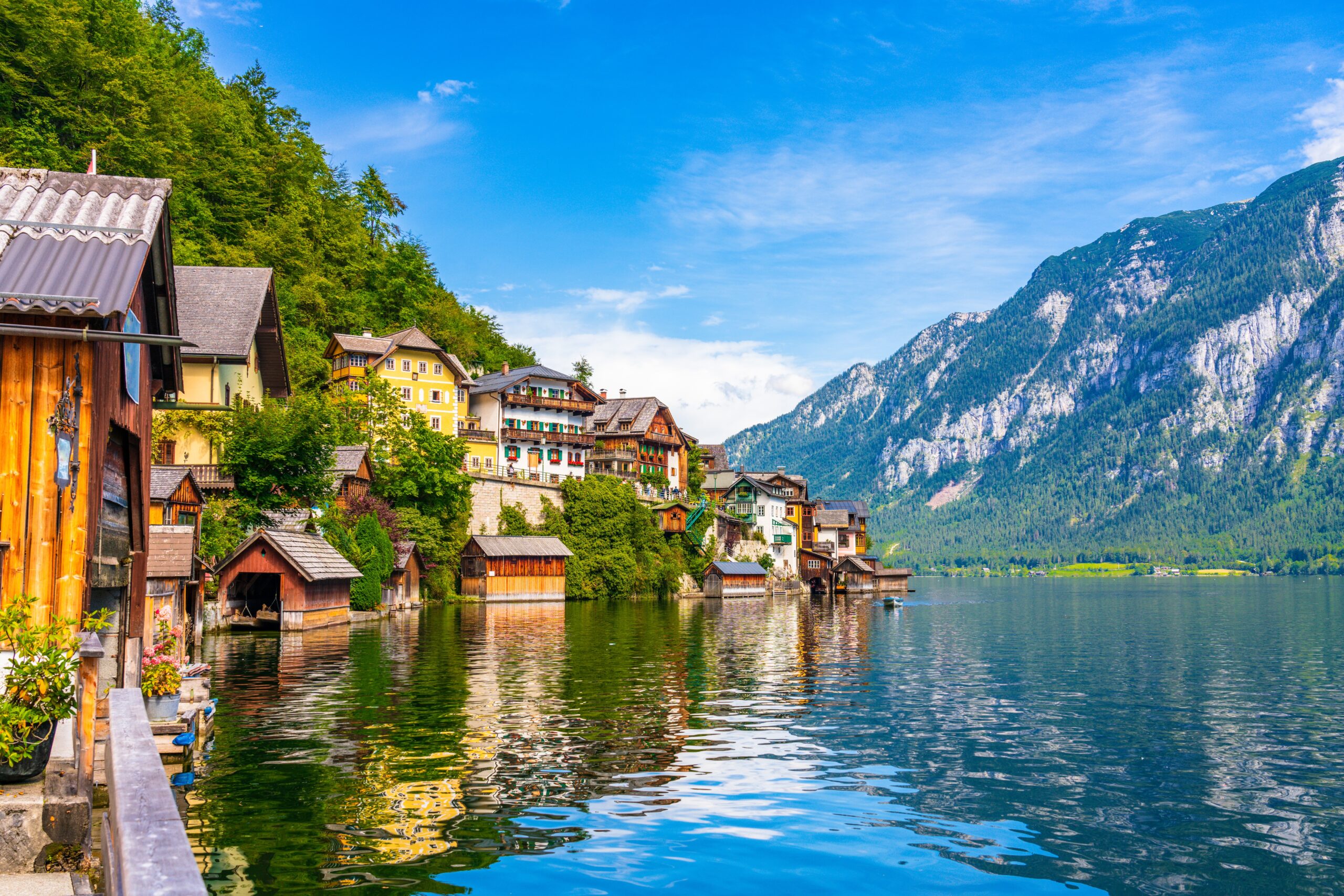 Hallstatt village in Austria with alpine houses beside lake Hallstätter See and mountains in the Salzkammergut region during summer