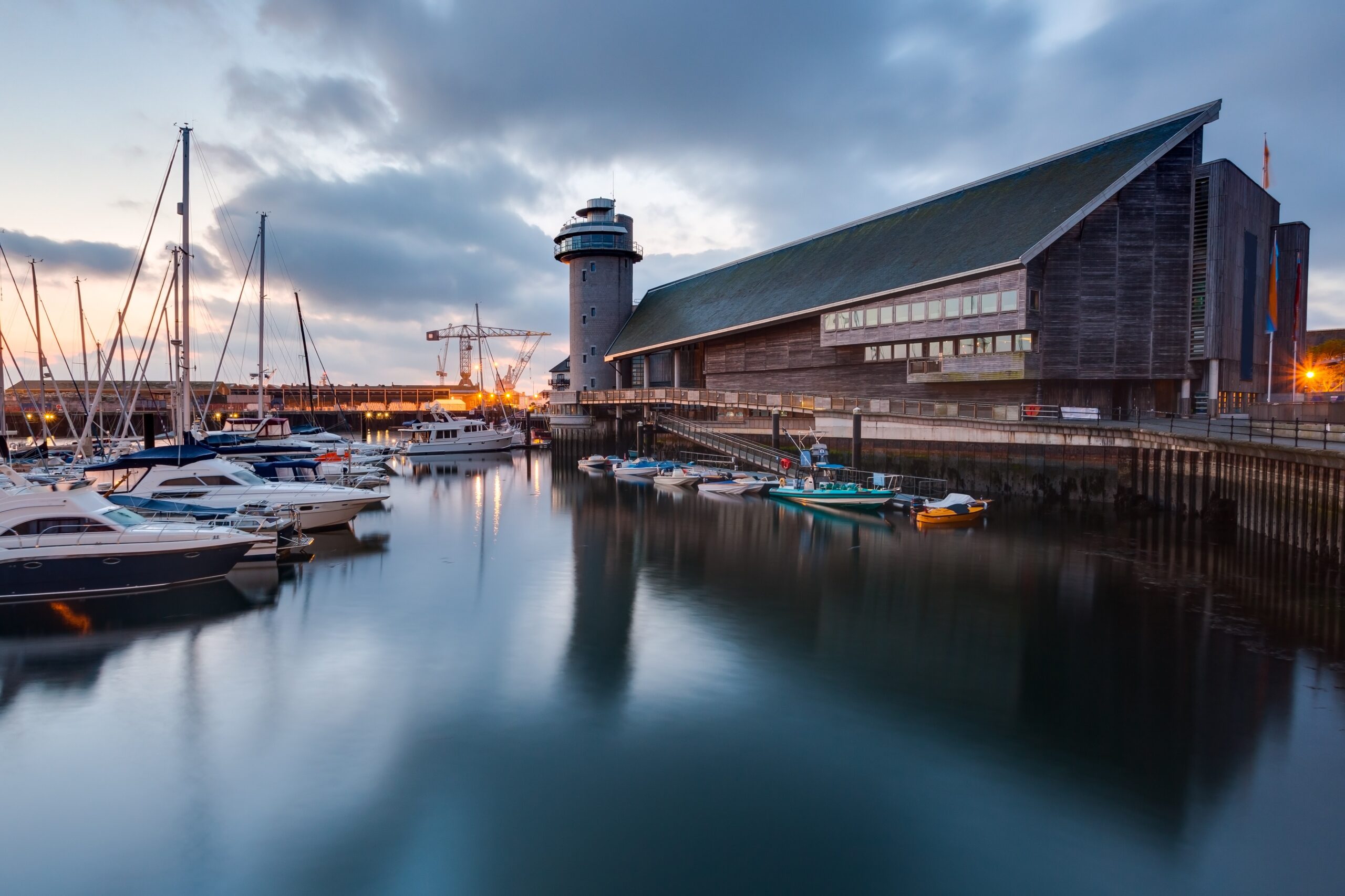 National Maritime Museum Cornwall in Falmouth harbour with boats and waterfront at sunset