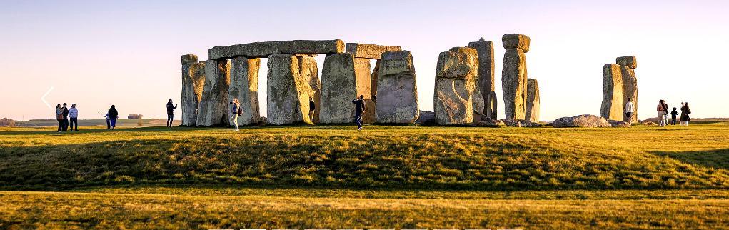 Stonehenge Inner Circle tour visitors walking among the stones during special access experience